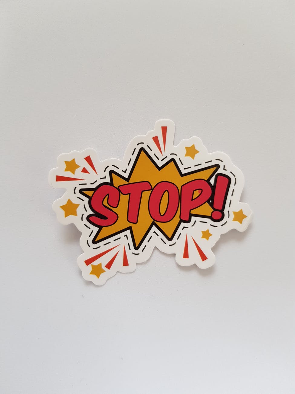 red and yellow stop sticker
